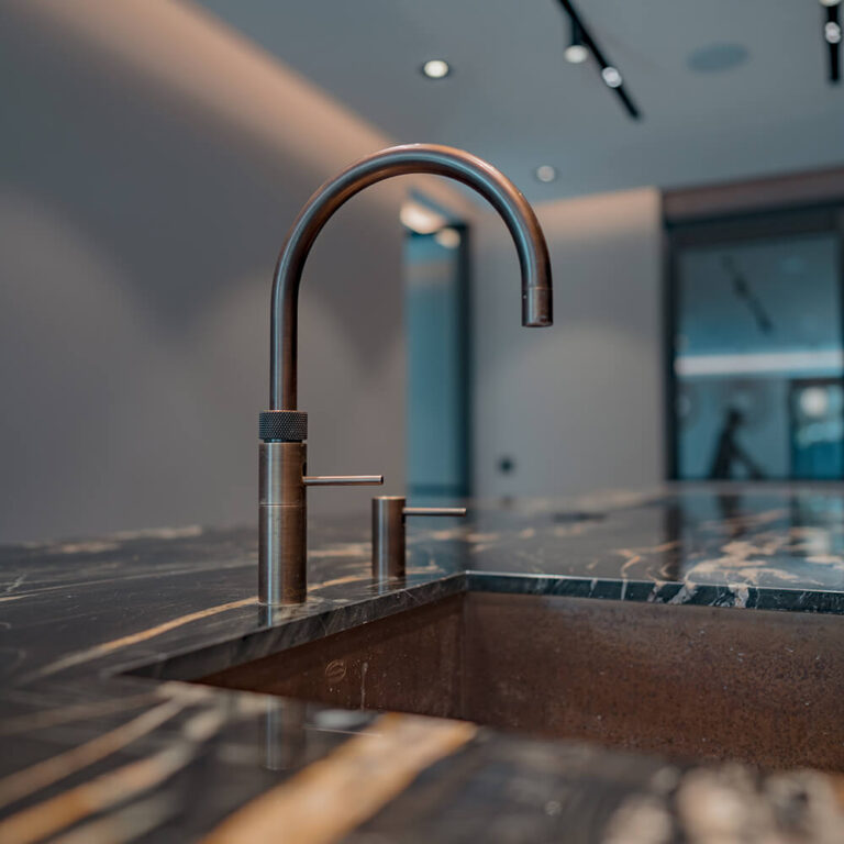 Moderne kraan op een marmeren werkblad