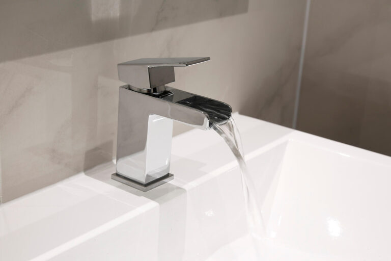 Moderne badkamerkraan op een witte wastafel